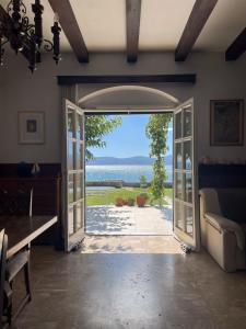 an open door with a view of the ocean at Beachfront Family Villa in Eretria