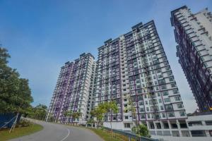 two tall apartment buildings on a street at Walid Guesthouse, cozy hill view in Ayer Keroh