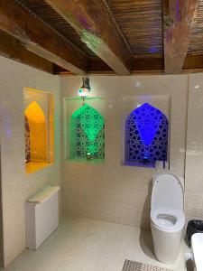 a bathroom with four stained glass windows on the wall at Mukhlisabegim Hotel in Bukhara +41 photos