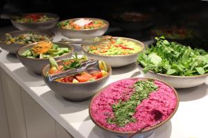 a buffet filled with bowls of different types of vegetables at Bonnie City Hotel in Antalya +54 photos