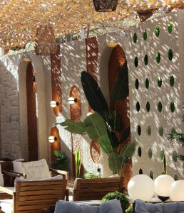 a dining room with tables and chairs and a wall at Bonnie City Hotel in Antalya