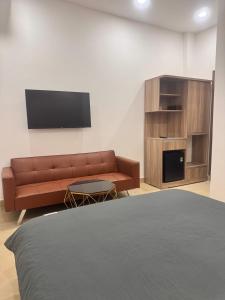 a living room with a couch and a tv at Cozy Home Airport - Self check-in 247 in Ho Chi Minh City