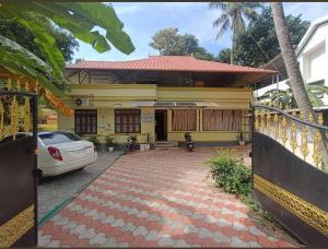 a house with a car parked in front of it at Ritu Heritage Homestay in Trivandrum