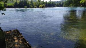 a view of a river from a dock at Kuća za odmor Una in Dvor