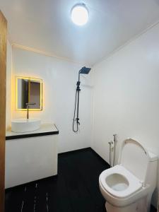 a bathroom with a toilet and a sink at Seaweed Village 2 in Pulau Sabangkat