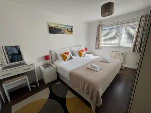 a bedroom with a bed and a tv in it at Sea View Bungalow in Carbis Bay Sleeps 6 in Carbis Bay