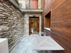 a stone building with a white bench in a hallway at Villmor - B23 - Corazón del Casco in Benasque