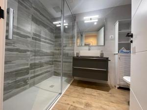 a bathroom with a sink and a glass shower at Villmor - B23 - Corazón del Casco in Benasque +10 photos