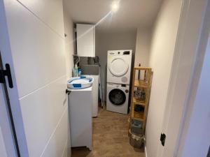 a small bathroom with a washing machine and a washer at Villmor - B23 - Corazón del Casco in Benasque