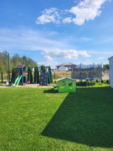 a park with a playground with a play equipment at Domki GAMA in Gąski