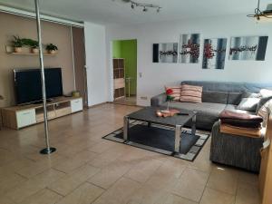 ein Wohnzimmer mit einer Couch und einem Tisch in der Unterkunft Dörrs vacation home with pool and garden in Weißbach