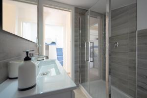 un bagno con un lavandino bianco e una doccia di Il Topazio a Vasto Altre 32 foto