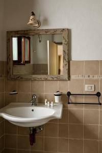 a bathroom with a sink and a mirror at Corte San Giorgio in Matino +59 photos