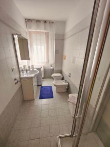 a bathroom with two toilets and a sink and a shower at Golden Hour House in Termoli +38 photos