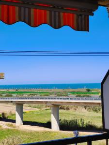 a long bridge with a highway in the background at Golden Hour House in Termoli