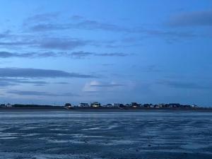 an empty runway with a blue sky in the background at Beach Bay Holiday Home in Camber +3 photos