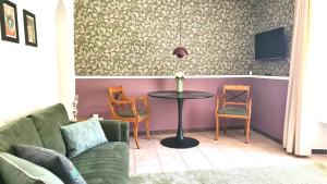 a living room with a table and chairs at Mosel-Side Junior Suite in Reil