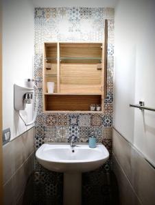 a bathroom with a sink and a cupboard at Guest House Lo specchio sul mare in Santa Flavia