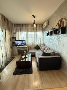 a living room with a couch and a table at Apartament Karina in Dudu