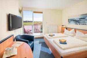 Postel nebo postele na pokoji v ubytování Hotel Strandburg