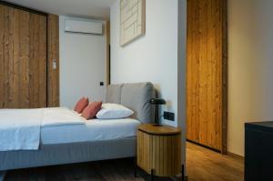 a bedroom with a bed and a lamp on a table at MT Suites ApartHotel in Budapest