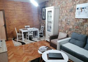 a living room with a couch and a table at TINAa in Kragujevac