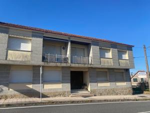an apartment building on the side of the street at Adro Vello in San Vicente de O Grove