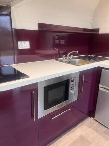 a kitchen with a microwave and a sink at Country Cabin in Hesket Newmarket