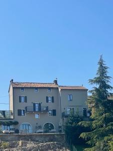 a large building with a tree in front of it at Villa Eleonora Italia in Mornico Losana
