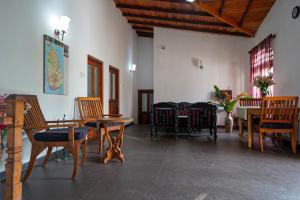 a room with wooden tables and chairs and a table at 4ty two Homestay Galle in Galle