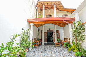 an entrance to a building with chairs and a porch at 4ty two Homestay Galle in Galle
