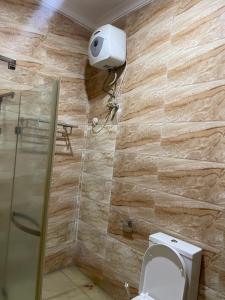 a bathroom with a toilet and a shower at Ibiyemi apartment in Abuja +59 photos