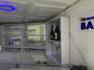 a bar with two bottles of wine and glasses at Ibiyemi apartment in Abuja