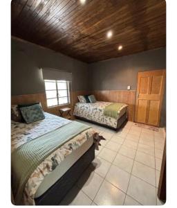 a bedroom with two beds and a window at Farm Apartment in Stampriet