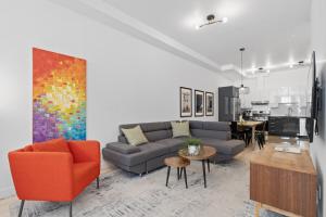 a living room with a couch and a table at New Modern 2bdr Apartment in Little Italy in Montréal