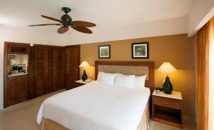 a bedroom with a white bed and a ceiling fan at Occidental Caribe - All Inclusive in Punta Cana