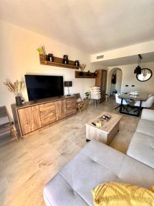 a living room with a large flat screen tv at Sweet Home II in Manilva