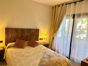 a bedroom with a bed and a large window at Sweet Home II in Manilva +17 photos