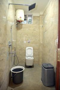 a small bathroom with a toilet and a shower at Sri Shine Villa Luxury 2 BHK & 1 BHK in Vijayawāda
