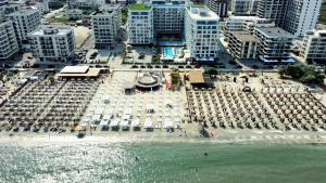 an aerial view of a beach with umbrellas and buildings at Sea Reflections in Infinity Pool & Spa Resort in Mamaia Sat/Năvodari