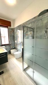 a bathroom with a glass shower and a sink at Appartamenti Gabicce Mare in Gabicce Mare
