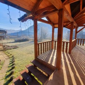 a wooden porch with a view of a field at Садиба Грицюка in Krivorovnya +26 photos