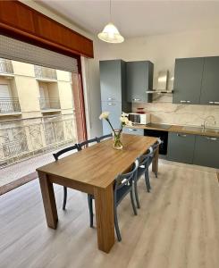 a kitchen with a wooden table and chairs and a kitchen with a kitchen at Appartamenti Gabicce Mare in Gabicce Mare +36 photos