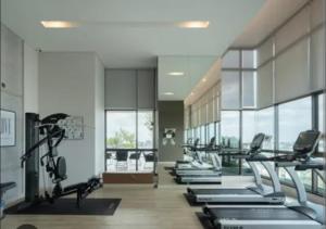 a gym with several treadmills and elliptical machines at Lumpini park chatuchak in Bangkok