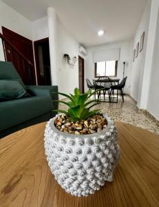 a large white vase sitting on a table in a living room at Las Casas Del Puente in Córdoba