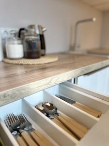 a drawer in a kitchen with wooden utensils at Central apartment, Self check-in in Tartu +7 photos