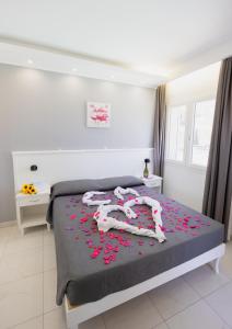 a bedroom with a bed covered in pink confetti at Residenza Kalios in Tropea