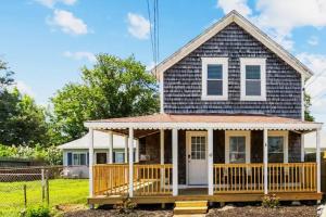 a small house with a porch and a deck at Portsmouth Beach cottage in Portsmouth