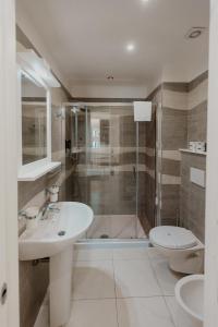 a bathroom with a shower and a sink and a toilet at Residenza Kalios in Tropea