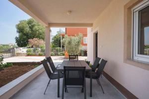 a dining table and chairs on a patio at Carpe Diem in Raslina
